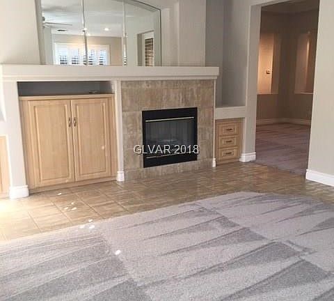 Family room with cabinetry and gas fireplace.