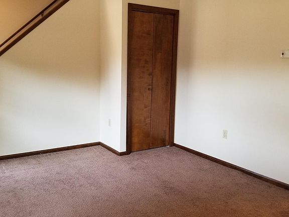 Living room closet and stairway to second floor