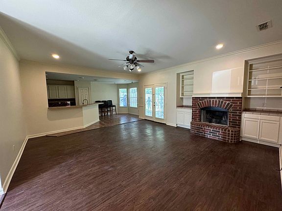 Living room with kitchen and breakfast room in the background.