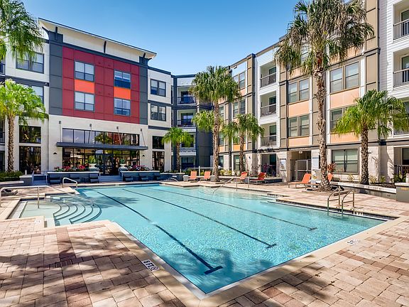 Resort-style swimming pool with lounge chairs