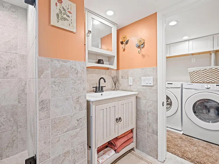 Sided by side NEW washer/dryer, full bathroom. Ceiling height is 6 1/2 feet.