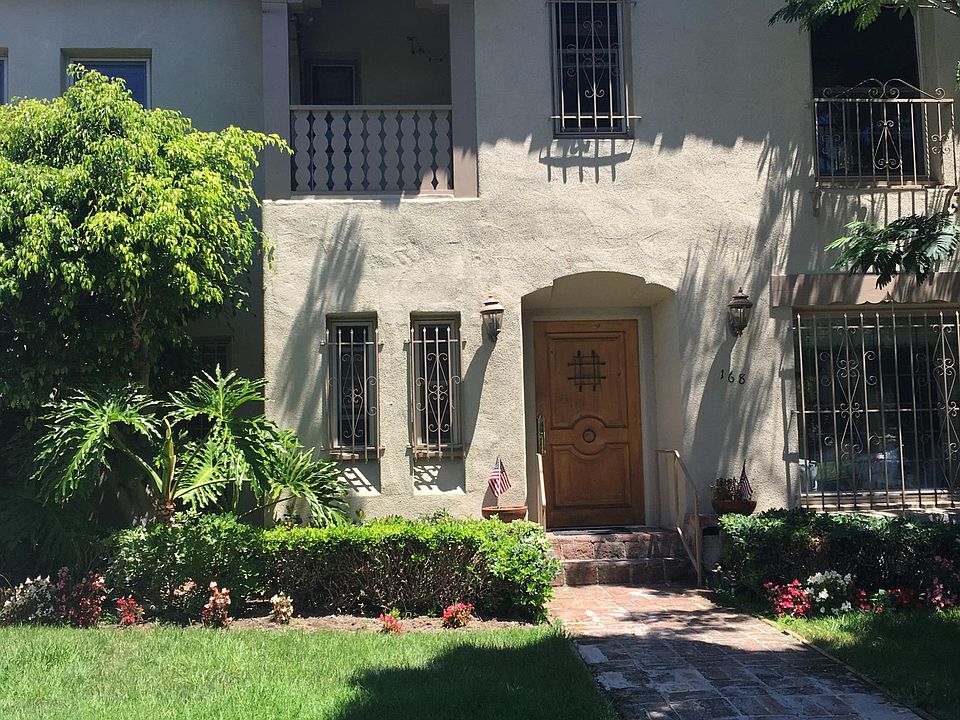 View of building from street. Unit is top left quadrant with patio.