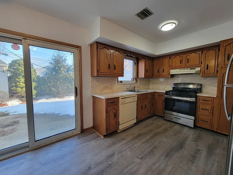 Kitchen with sliders to Patio