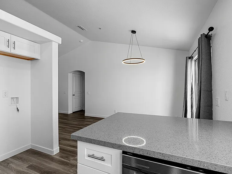 Refrigerator hook up to the left. Dining area. House to garage door in the background to the left. Slider to the right.