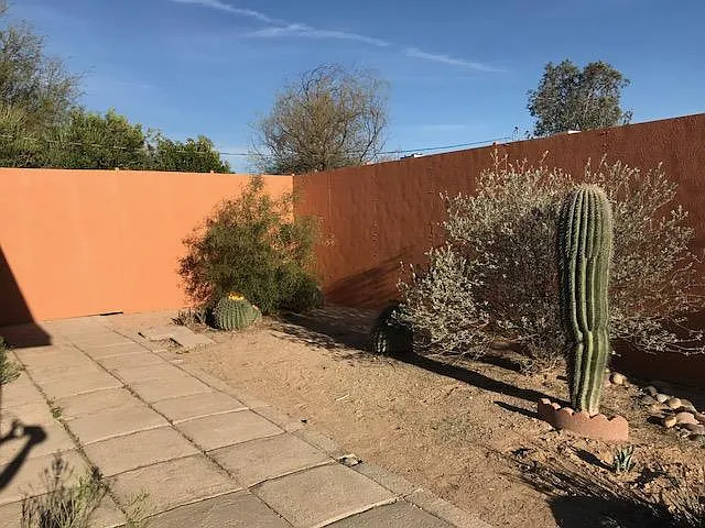 Back yard with 7 foot privacy wall.