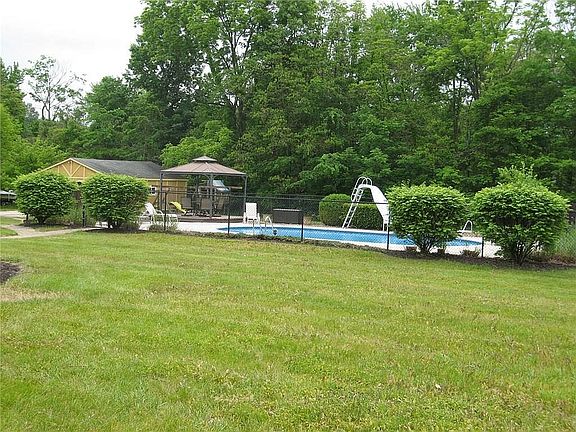 Fenced-in pool w/ pergola