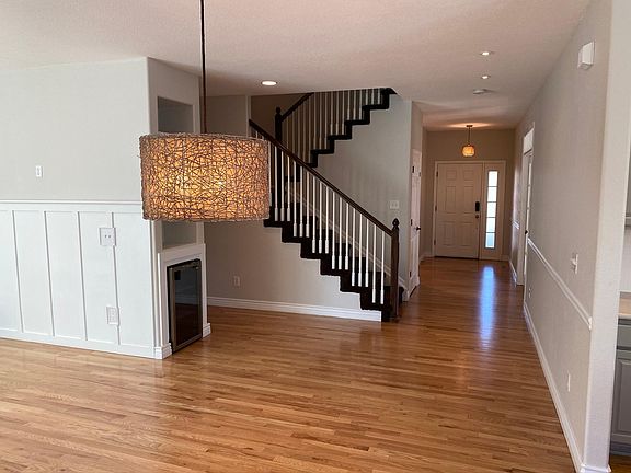 View from backyard door to front with Great Room to left and Kitchen to right (hallway to Powder to left of stairs and door to basement just past stairs)