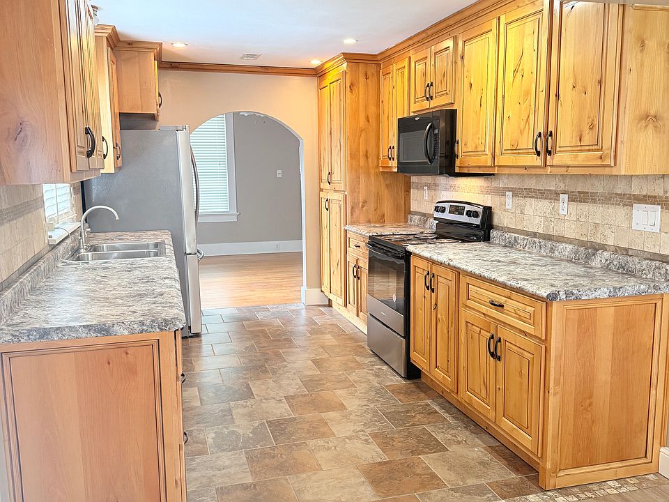 Another view of the kitchen, with all new appliances and custom cabinets.