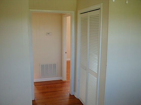Looking from dining area into hall with utility closet on right