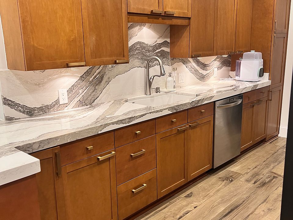 Kitchen features beautiful marble countertops and backsplash and RH cabinets and hardware.