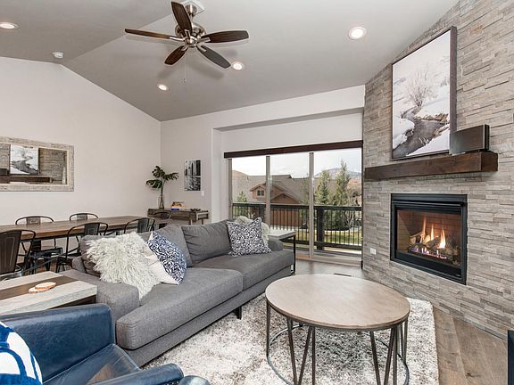 Leather couch seating and chairs, fireplace, and 55 " Smart TV with paid cable