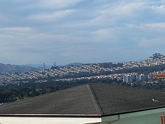 Distant view of GG Bridge and ocean from living/dining room windows