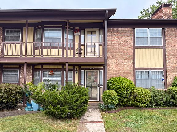 Exterior of Building, lower unit with direct path, and 2 covered parking areas in front of unit