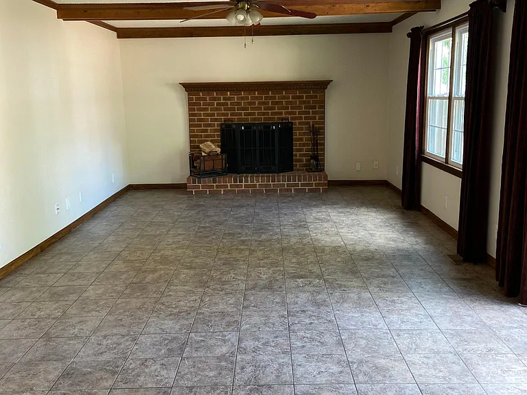 Family room with wood burning fireplace open to kitchen.