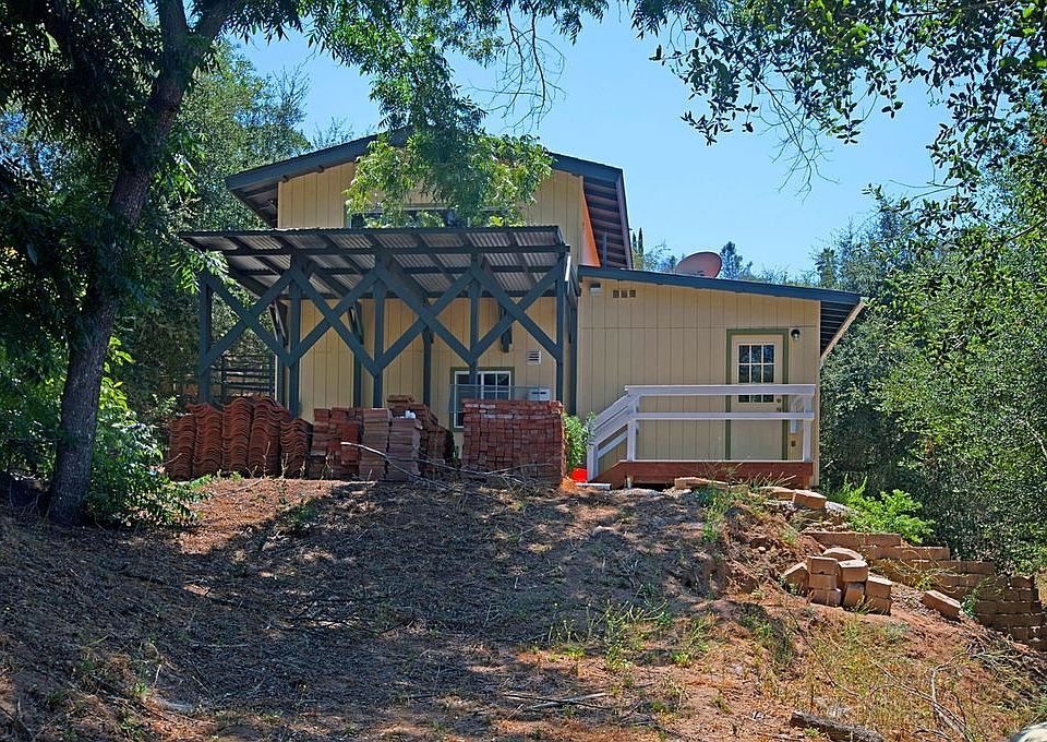 view from side yard (front door on left) and car port