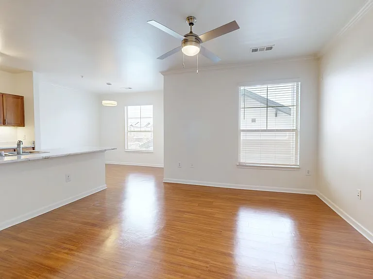 Apartment Dining and Living Room with Wood Style Flooring.