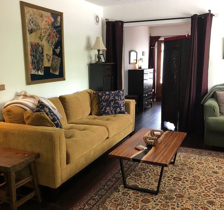 Living room overlooking far bedroom with curtained closures