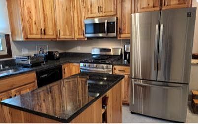 Beautiful hickory cabinets with granite countertops and backsplash