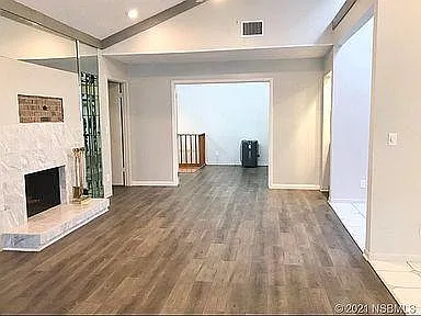 Spacious living room features a gas fireplace and wet bar.