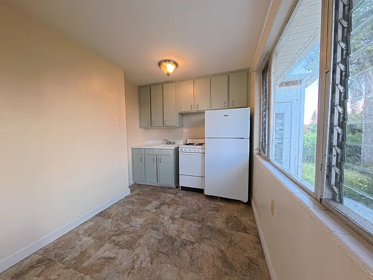 Kitchen with refrigerator, oven and range