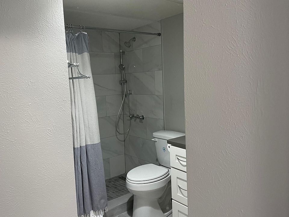 Beautiful updated bath has large format tile, upgraded shower spray, and updated vanity with good storage.