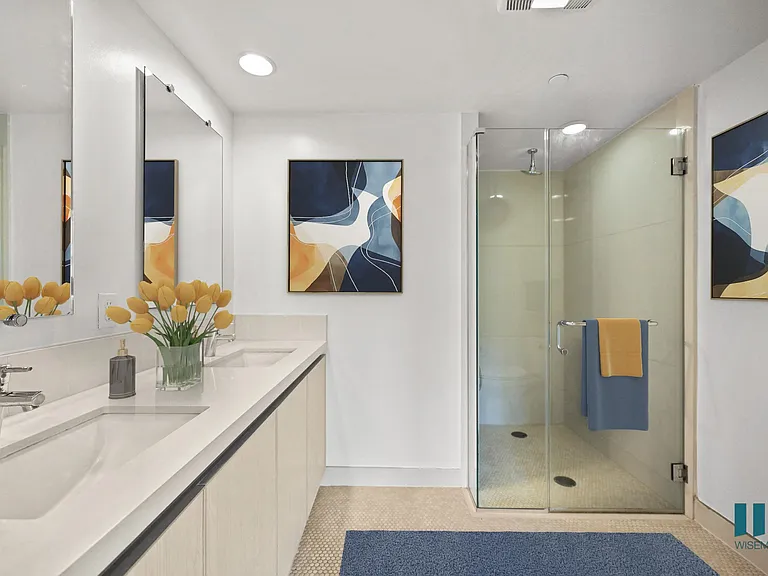 Bathroom with Walk-In Shower, Double-Sink Vanity, and Cabinet Storage