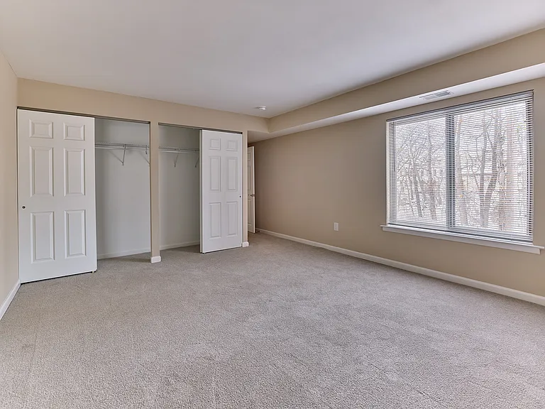 Primary bedroom with oversized window and generous double closets in this 2 bedroom, 2 bathroom apartment at North Crossing in Willow Grove, PA.