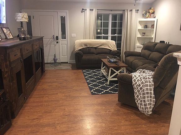 Beautiful floors in the living room with vaulted ceiling and open to kitchen/dining area.