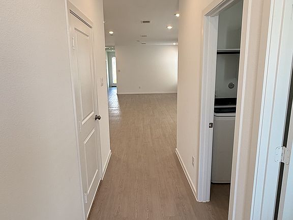 As you enter this beautiful property, you'll find a conveniently located half bathroom to your right, followed by an efficient and stylish washer and dryer setupa??making daily living both functional and elegant.