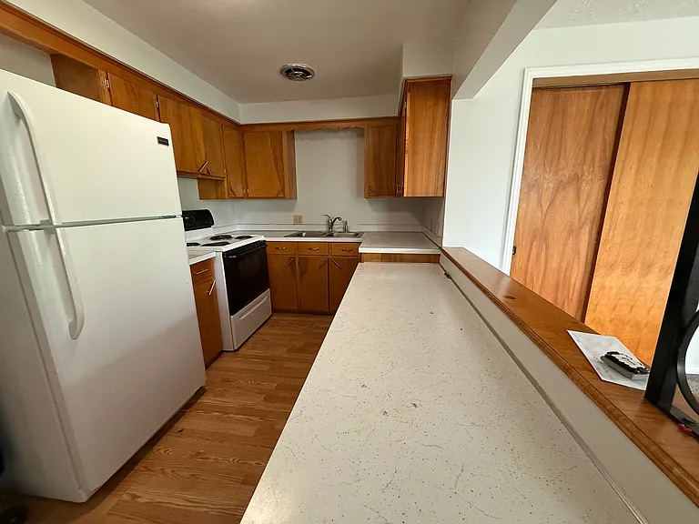 Kitchen includes refrigerator and range
