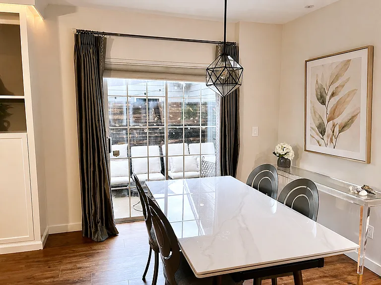 Dining room. This dining table and credenza can stay in the unit if preferred. This dining table extends to seat 8 people.
