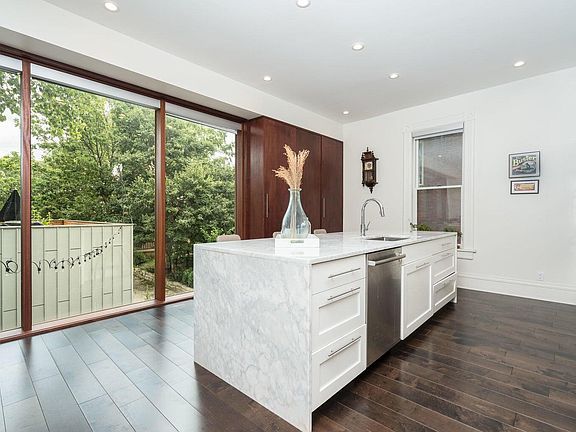 Gorgeous Modern Kitchen - Abundant natural light, Quartz countertops, sleek White cabinetry, stainless steel appliances, and large island w/ bonus seating!