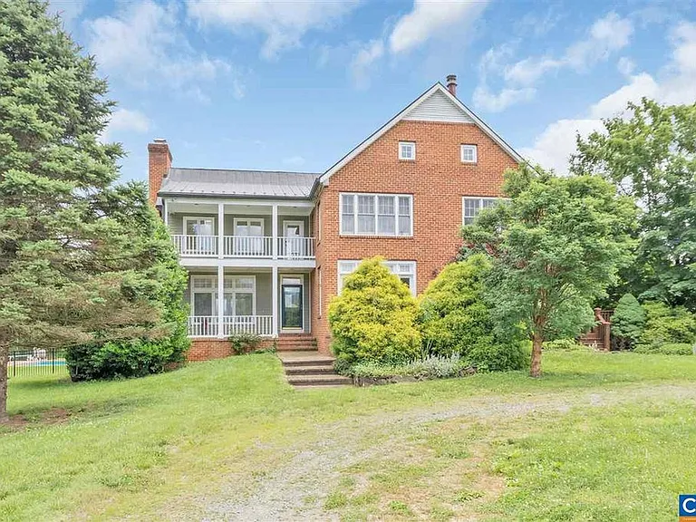 This is the front of the house. It is landscaped with some lovely specimen trees. You can see the upstairs and downstairs porches. The upstairs porch is accessed from the master bedroom.
