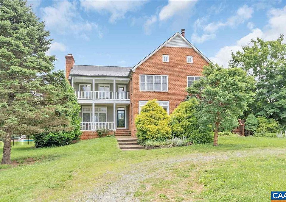 This is the front of the house. It is landscaped with some lovely specimen trees. You can see the upstairs and downstairs porches. The upstairs porch is accessed from the master bedroom.