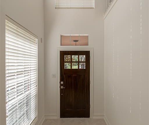 Dramatic two story entry way with custom design lighting.