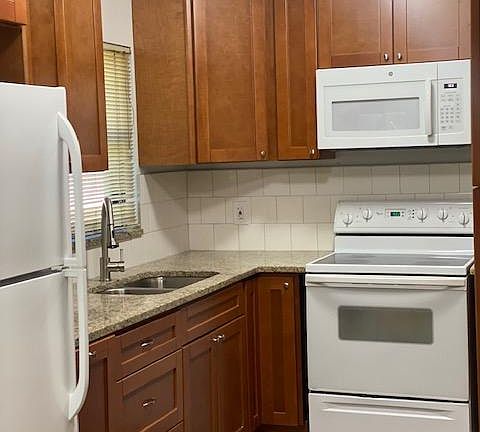Kitchen with new appliances, ample counter space and storage - with an adjacent dining area