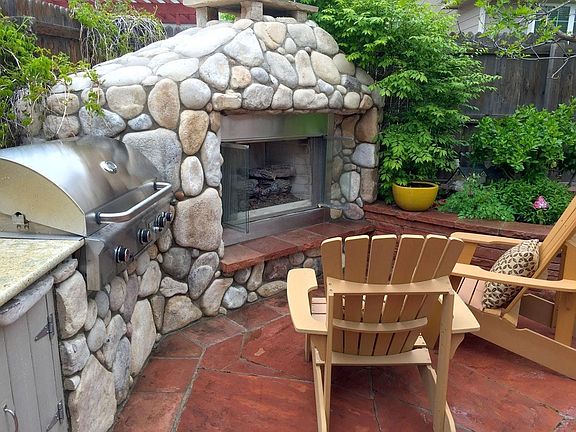Backyard with gas fireplace, built-in professional grill.
