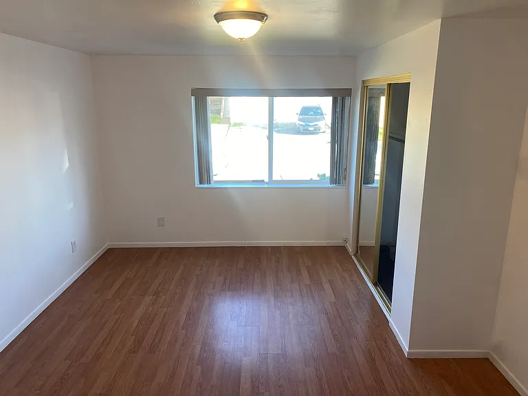 Bedroom with closet & has Pergo floors