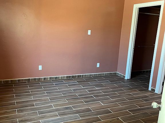 Bedroom with one closet (has door), separate from kitchen/living room area