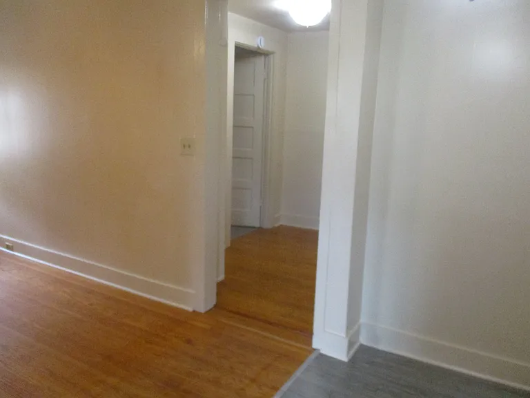 Living room (left) Hallway, Bathroom door (left) Dining area (right)