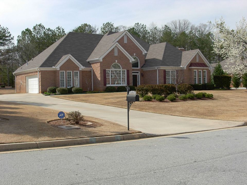view of three sides brick home