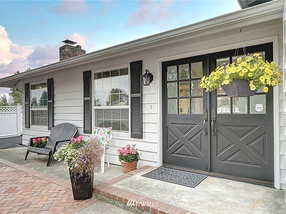 Classic colonial crossbuck double doors enter into this lovely home.