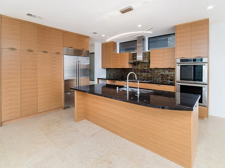 Custom kitchen with massive island, large farmhouse sink, and designer pulls.