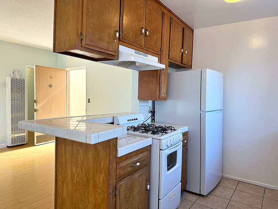 Open Kitchen with gas stove and refrigerator