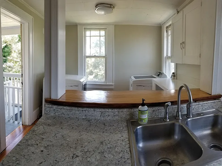 Kitchen looking over laundry area and door to back porch
