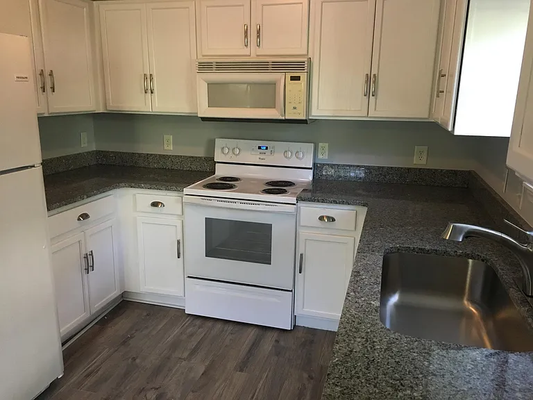 New granite with oversized farm sink, refrigerator and stove