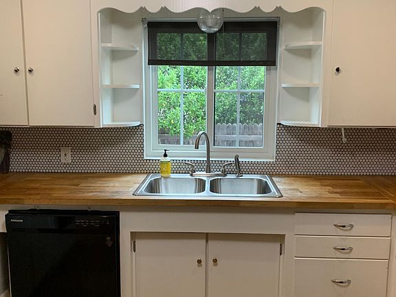 Cute kitchen with dishwasher, microwave, oven, gas stove & side-by-side refrigerator