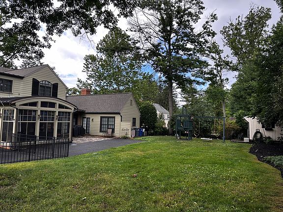 The backyard of the house with an extended driveway.