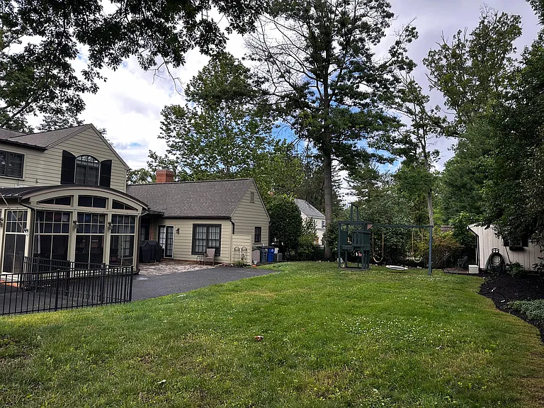 The backyard of the house with an extended driveway.