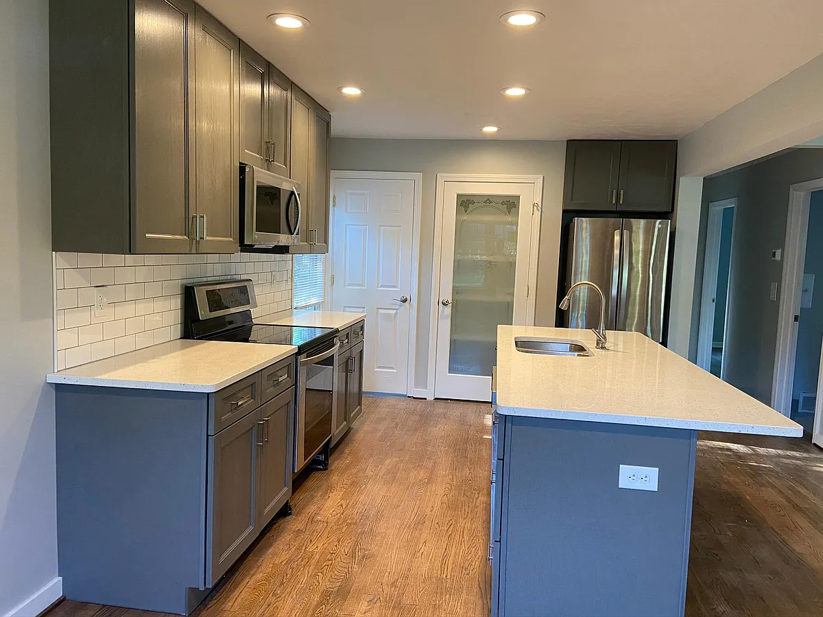 Kitchen with pantry closet and island with seating - 27824 Rexford Rd